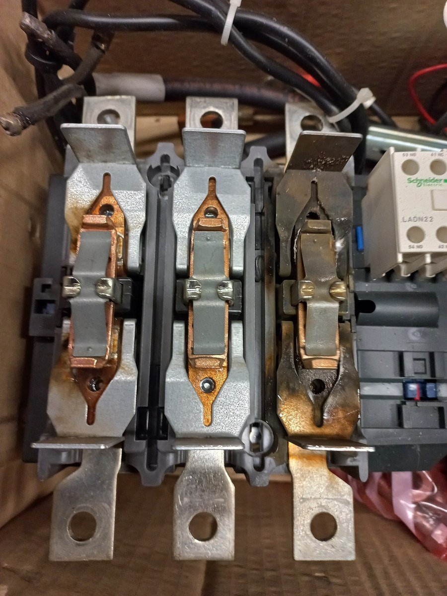 Burned main contact poles of an industrial AC contactor showing severe arc erosion